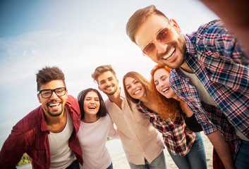 Group of young people having fun outdoors on the beach 