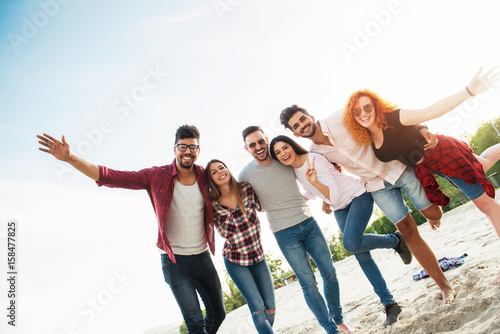 Group of young people having fun outdoors on the beach 