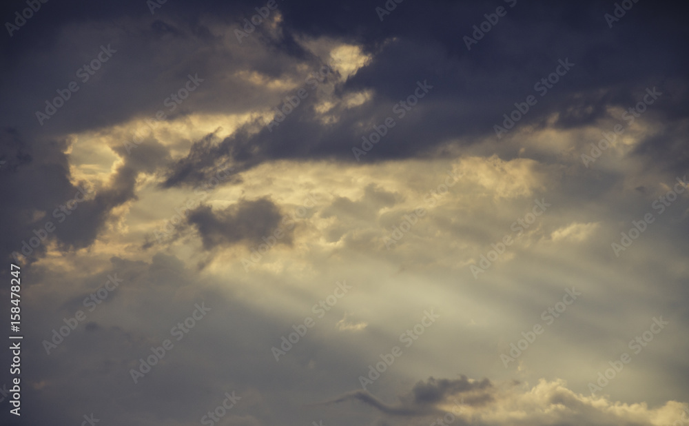 Rays of light break through dark clouds Rays of light break through dark clouds