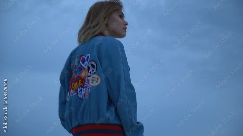 Blonde in denim jacket, rear view Blonde in denim jacket, rear view