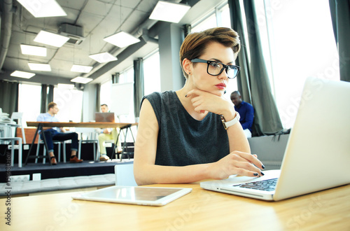 Hipster Woman use Laptop huge Loft Studio.Student Researching Process Work.Young Business Team Working Creative Startup modern Office.Analyze market stock new strategy.Blurred film effect.