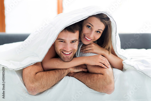 Couple under bed covers 