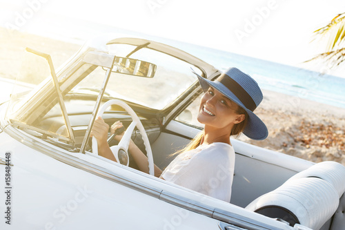 Photography Beautiful woman in blue hat and white retro cabriolet