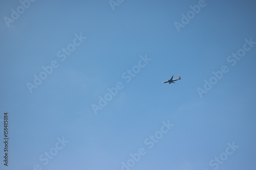 Cloudless clear blue sky. Background. And a plane is flying. Go on holiday and arrive safely and on time. 