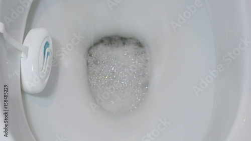 Flushing the water in a ceramic toilet