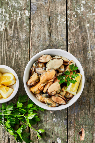 Mussels with lemon and herbs. Shellfish seafood. Delicious snack for gourmands.Top view