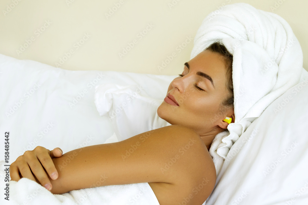Woman is using earplugs for sleeping Woman is using earplugs for sleeping