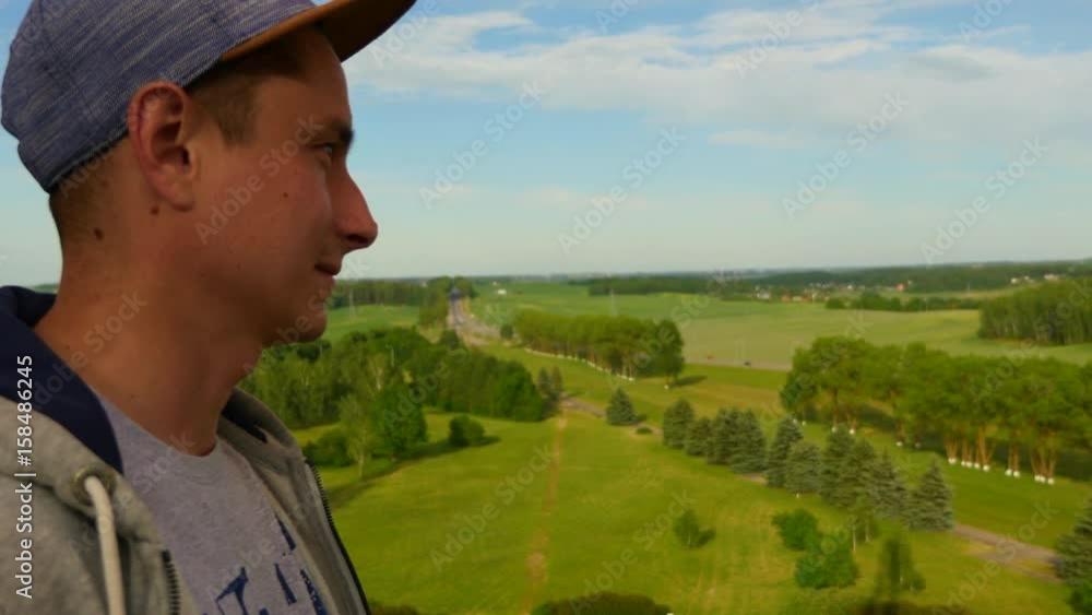 Young man on top of a mountain enjoy the beautiful view of nature. Close up top view.