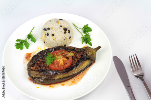 Turkish cuisine. Karniyarik and rice pilaf with black corinth raisin. Eggplant stuffed ground meat.