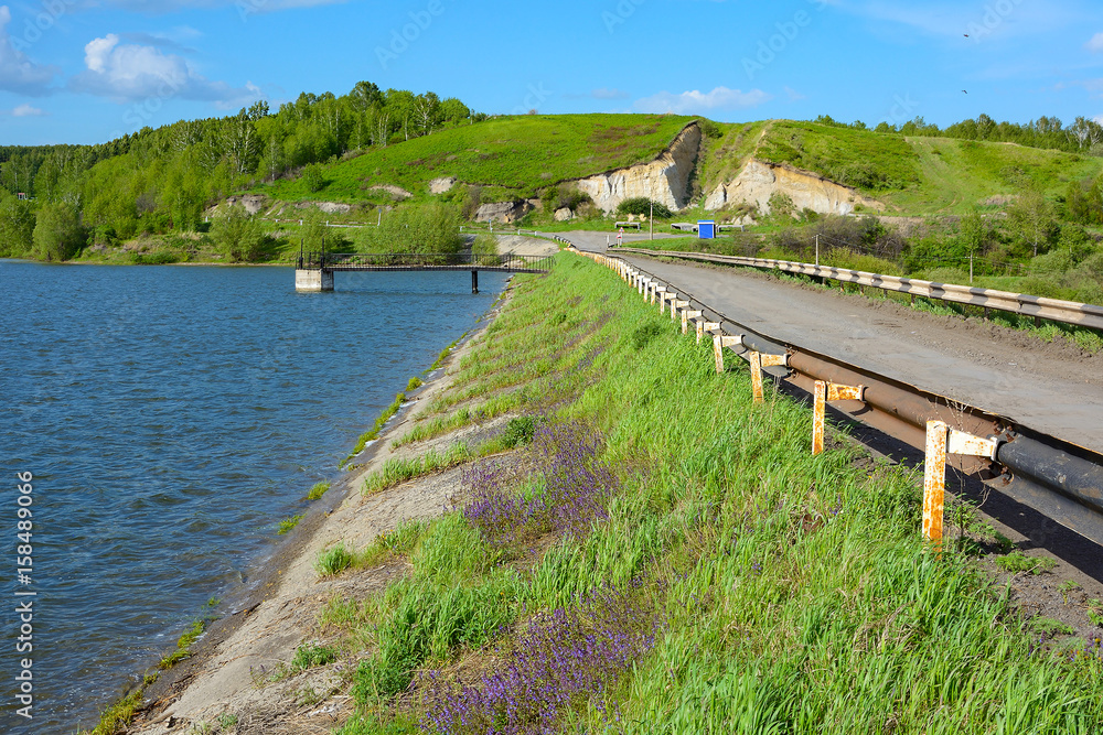 The road through the dam of the Barachatsky reservoir