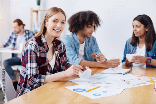 Cheerful vibrant woman having a lunch break with her colleagues