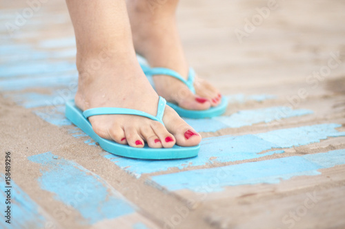 Lady's feet in sandals on beach