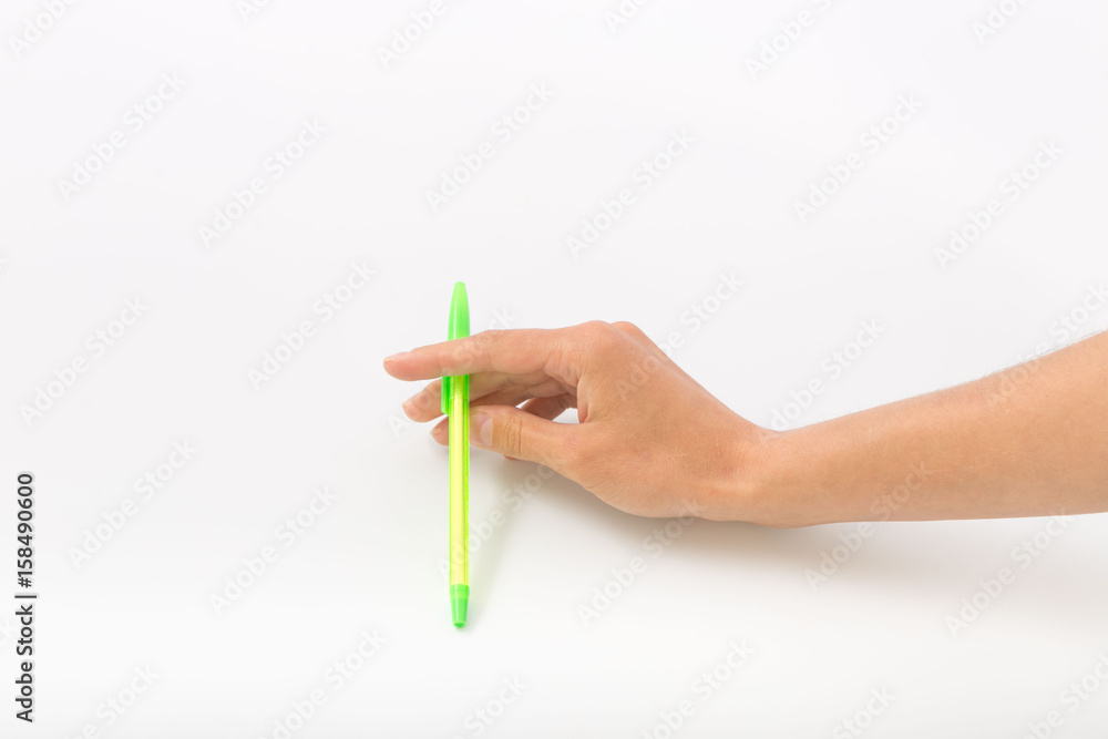 Female hands on a white background with a pen Female hands on a white background with a pen