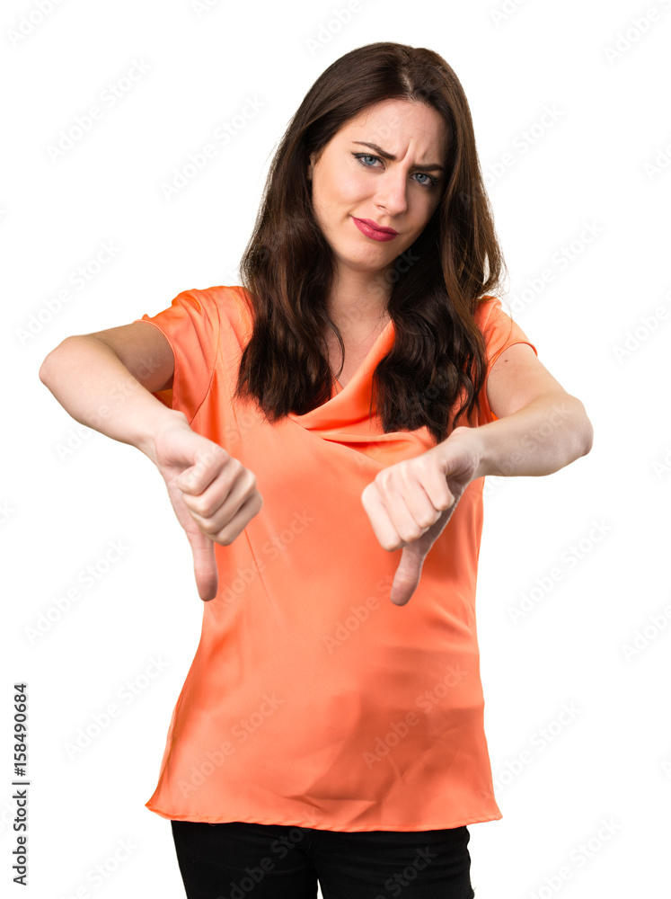 Beautiful young girl making bad signal Beautiful young girl making bad signal