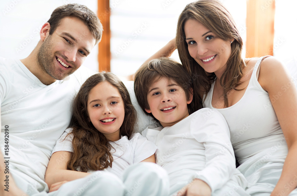 Smiling family in bed
Smiling family in bed