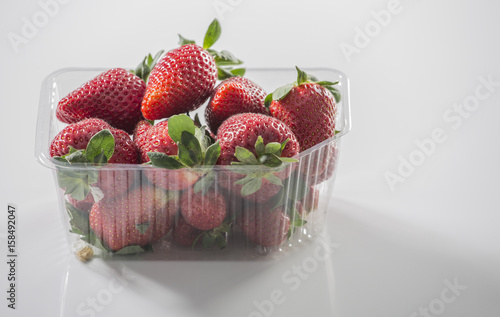 Fresh strawberry on gray background . Red strawberry. Loosely laid strawberries in different positions. Copyspace.