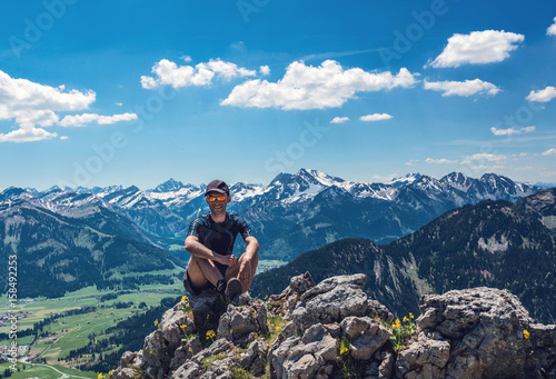 Happy hiker enjoying the nature on summit