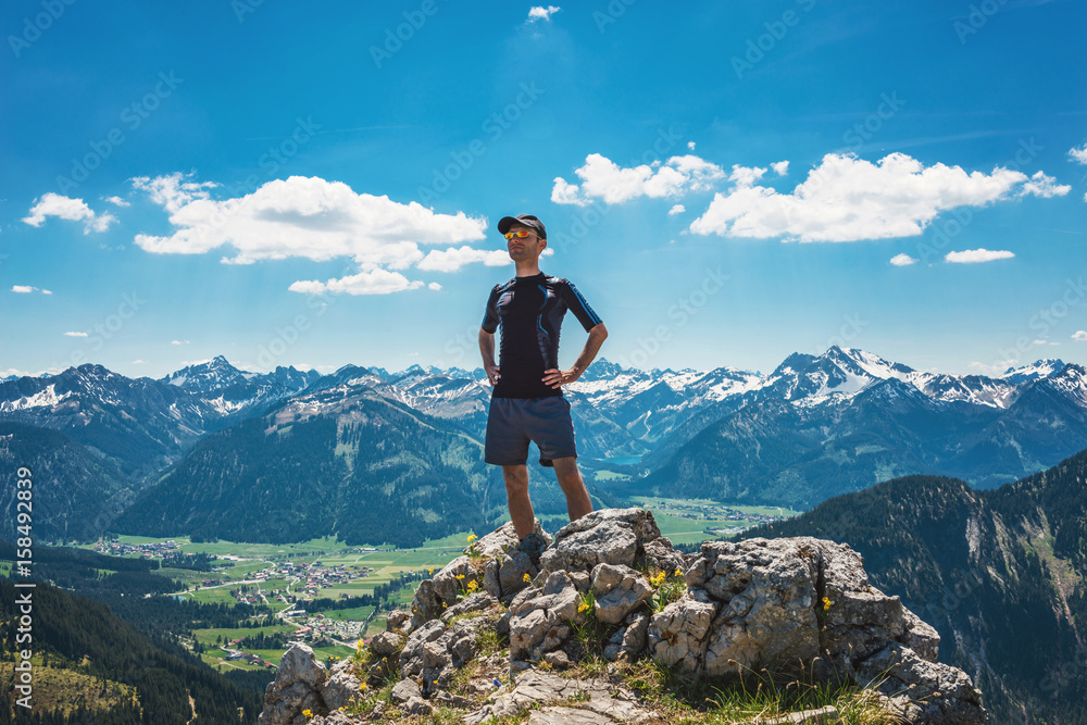 Confident hiker on mountain summit