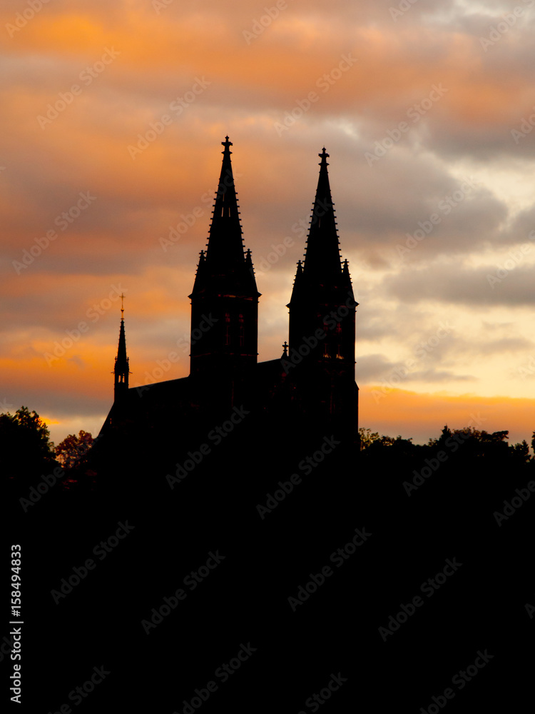 Basilica of Saint Peter and Paul on Vysehrad. Black silhouette of two towers on evening sky, Prague, Czech Republic.