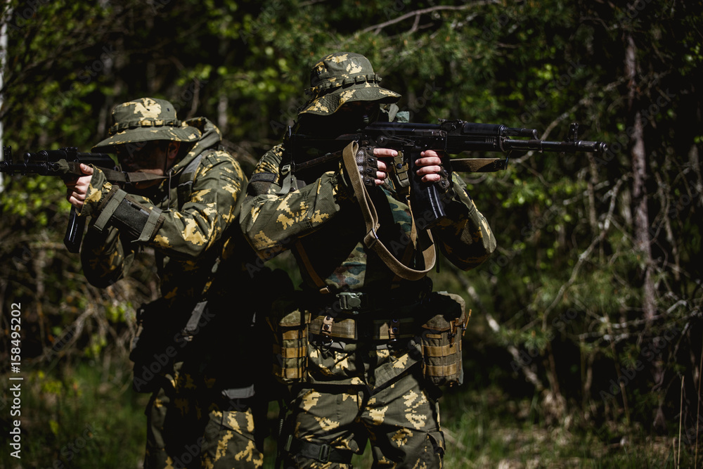 Fototapeta premium Military men with submachine gun
