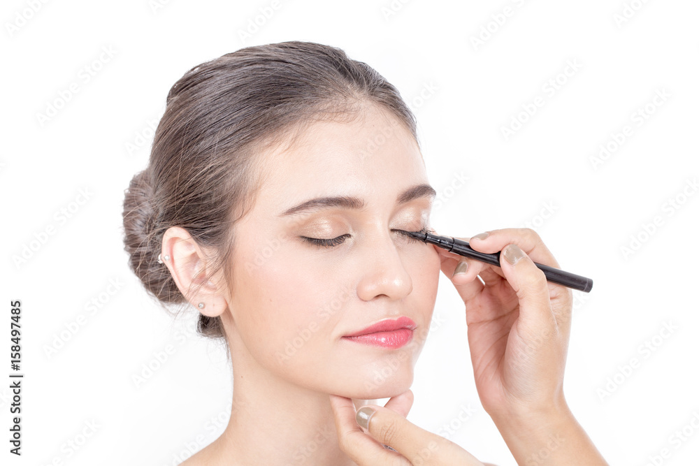 Makeup artist applies brushed at woman face. Beautiful woman face. Perfect makeup, isolated on white background, 20s year old. Makeup artist applies brushed at woman face. Beautiful woman face. Perfect makeup, isolated on white background, 20s year old.