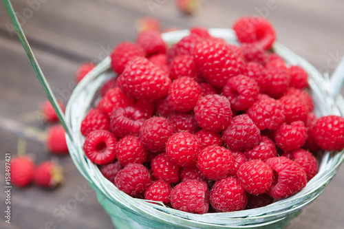 Basket with raspberries closeup, summer harvest