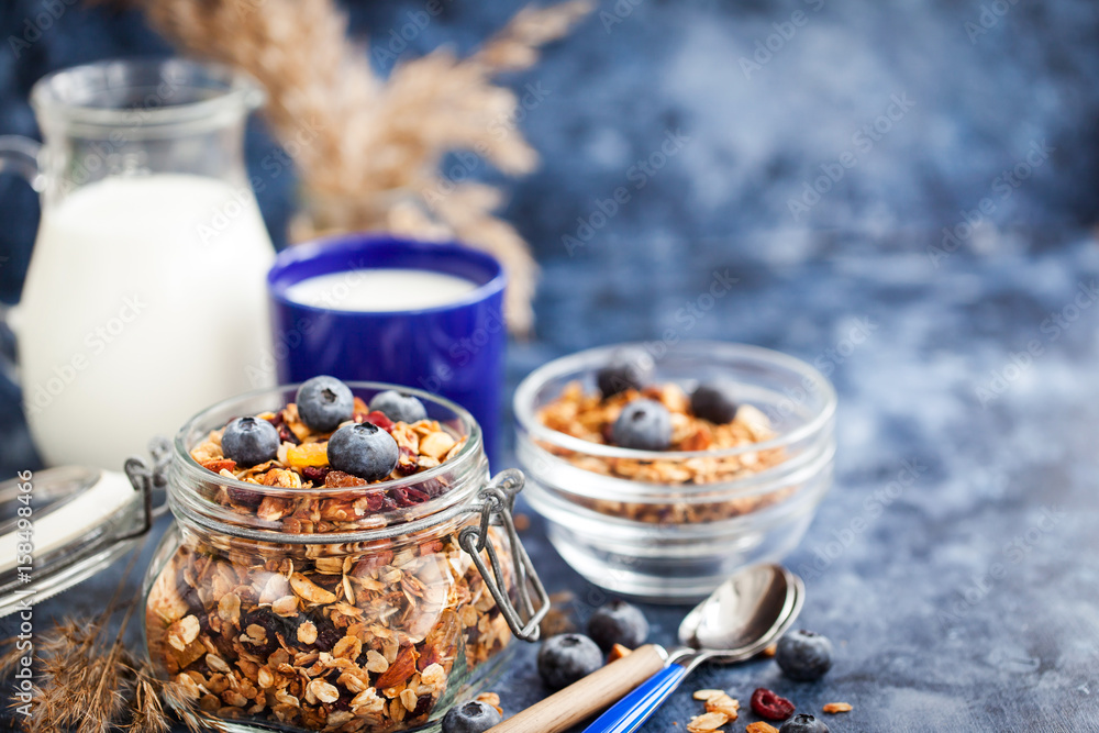 Homemade granola in jar, fresh blueberry and milk Homemade granola in jar, fresh blueberry and milk