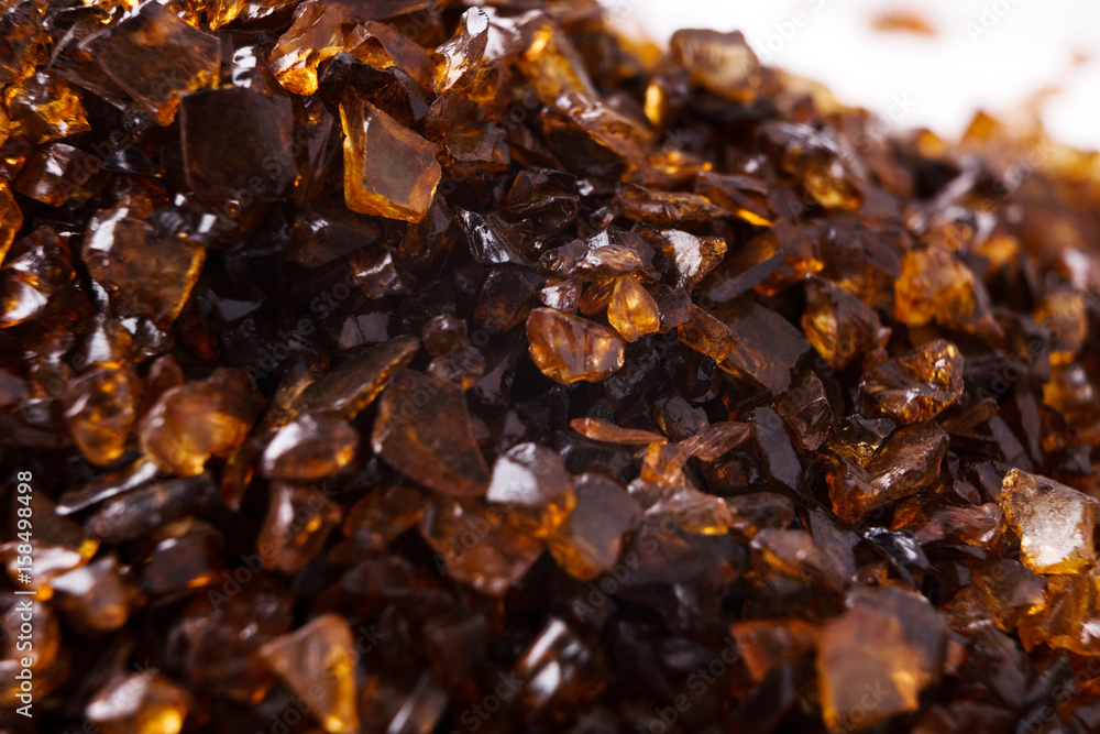 Heap of brown Amber stones on white background