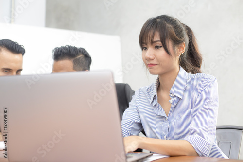 Young woman using laptop for work at modern place, Business people working in modern office. Greeting deal concept