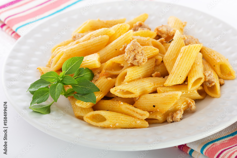 Pasta Bolognese with meat and Basil on a white plate Pasta Bolognese with meat and Basil on a white plate