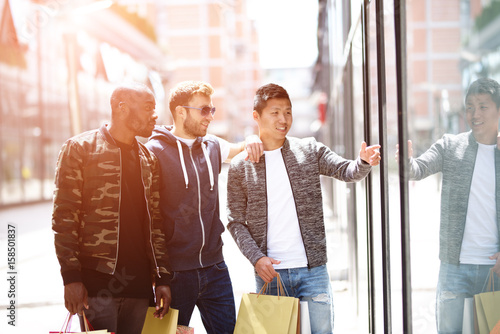 Three guys shopping- Men shopping in urban setting photo
