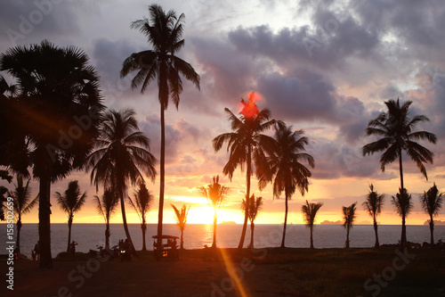 Travel to island Koh Lanta  Thailand. Palms tree on the background of the colorful sunset and cloudy sky.