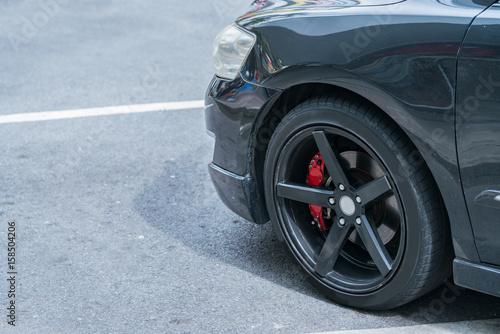 Brake Disc and Red Calliper, Car wheel with copy space. © KissShot