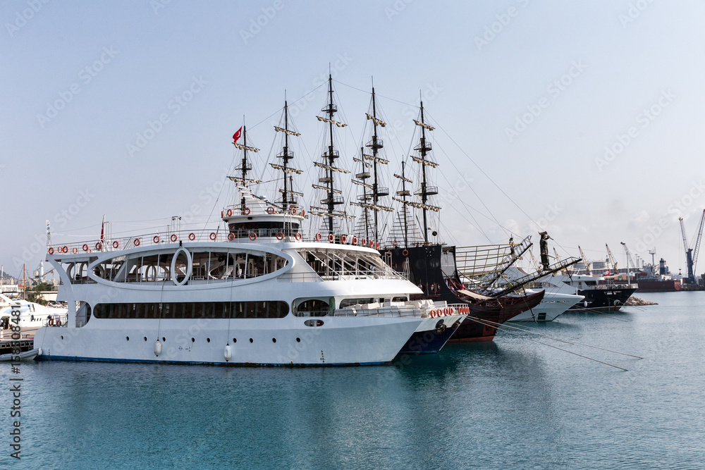 Yachts, pleasure boats and container ships in the port