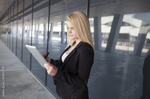Free Download Happy businesswoman holding a digital tablet. - GFXLoad