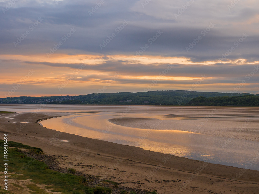 Beautiful early summer evening sunset over the beach and water at Arnside, Lancashire, UK Beautiful early summer evening sunset over the beach and water at Arnside, Lancashire, UK