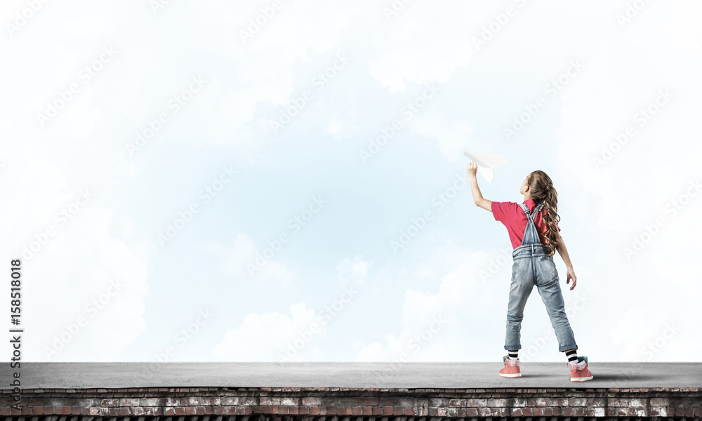 Concept of careless happy childhood with girl dreaming to become Concept of careless happy childhood with girl dreaming to become