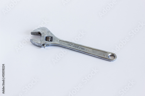 Iron adjustable wrench. Swivel shiny metal key close-up. © eremin
