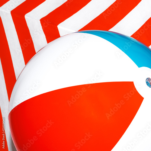 Beach ball on striped background. Minimal photo