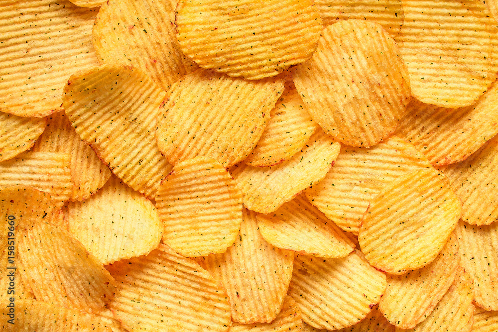 Yellow salted potato chips as background Yellow salted potato chips as background