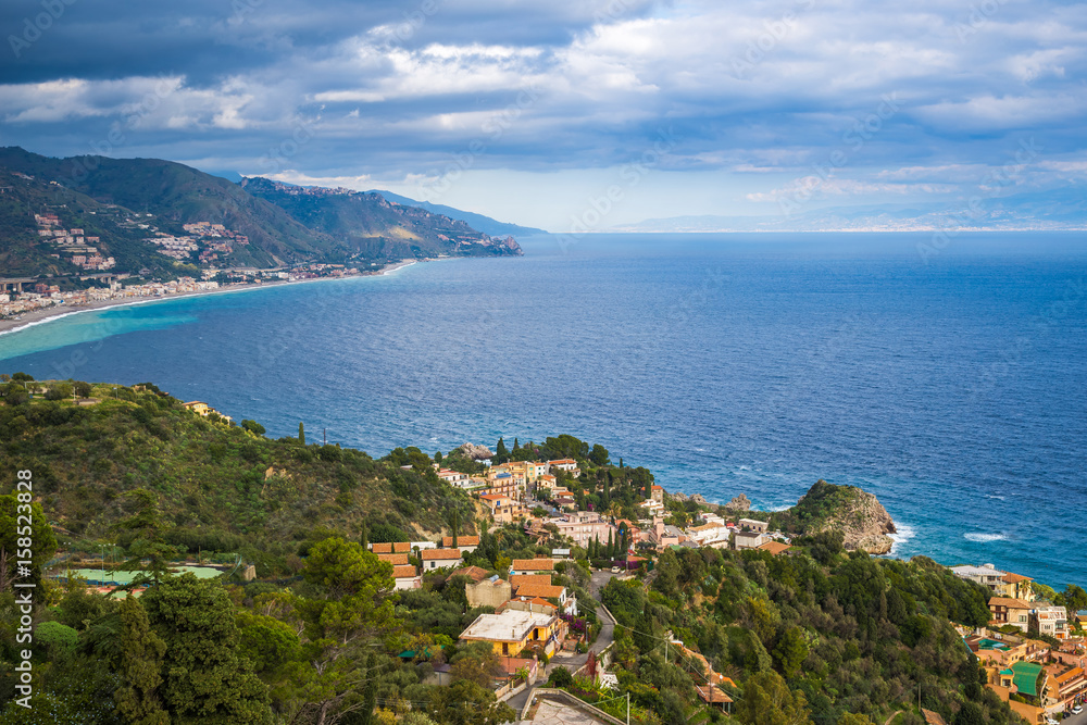 Taormina, Italy - Panoramic view of Taormina, Mazzaró with the shores of Italy at the background
