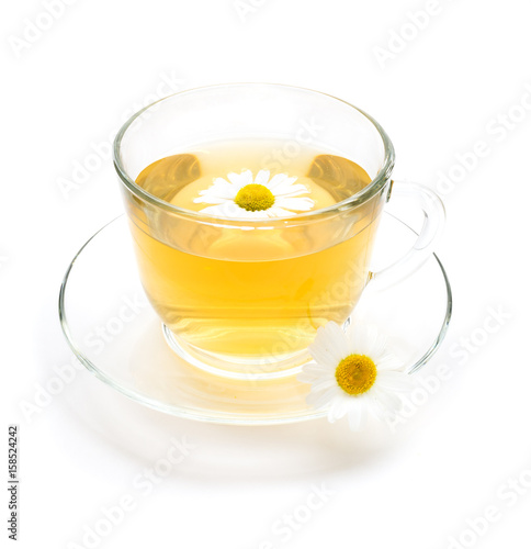 Transparent cup of chamomile tea with camomile flowers
