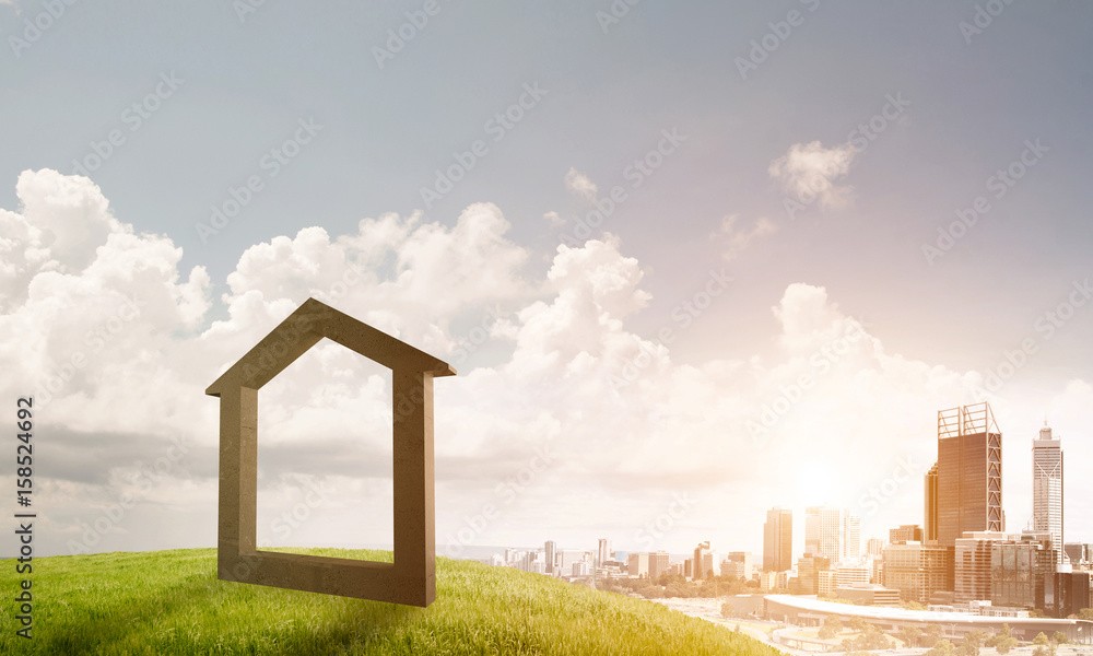 Conceptual image of concrete home sign on hill and natural lands Conceptual image of concrete home sign on hill and natural lands