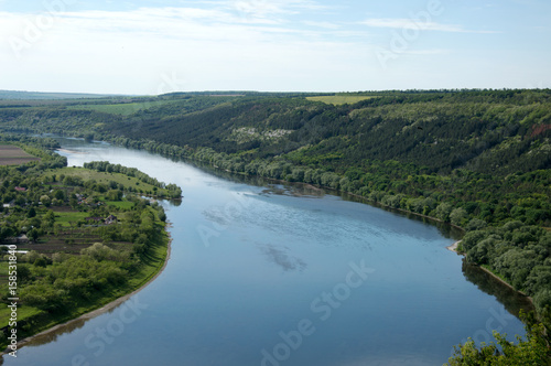 storks fly over the river a panorama of the mouth of the river a flight of storks great views of the river the panorama of the river Dnister Ukrainian river
