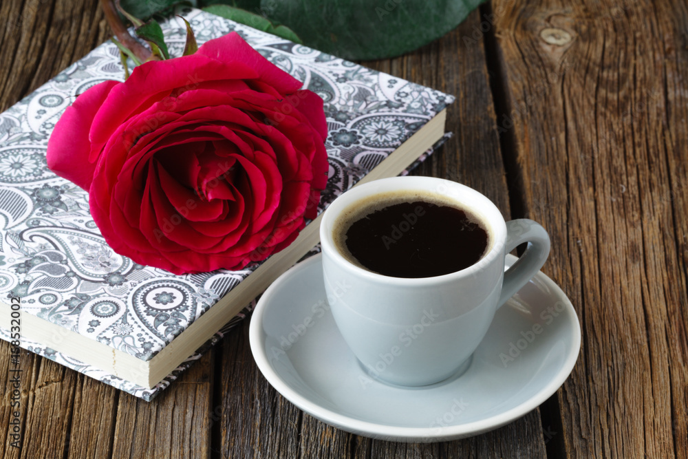 One red roses on the notebook. One red roses on the notebook.