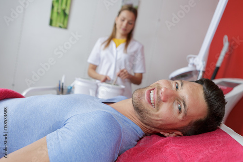 Portrait of man on beautician's bed