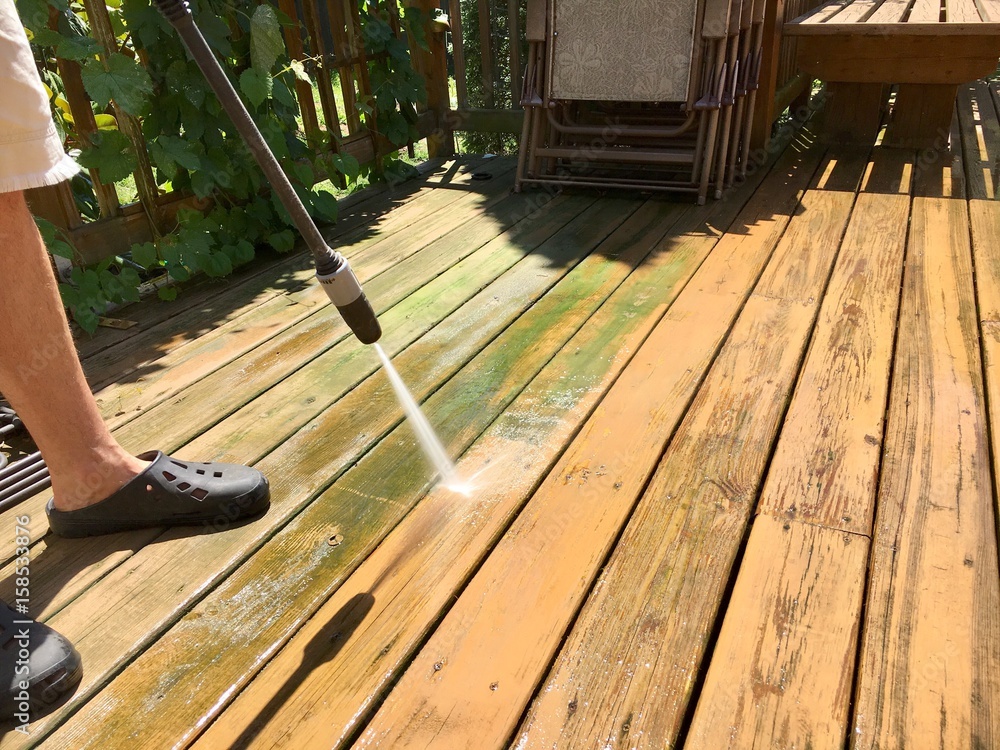 Cleaning wooden deck with pressure washer - obrazy, fototapety, plakaty 