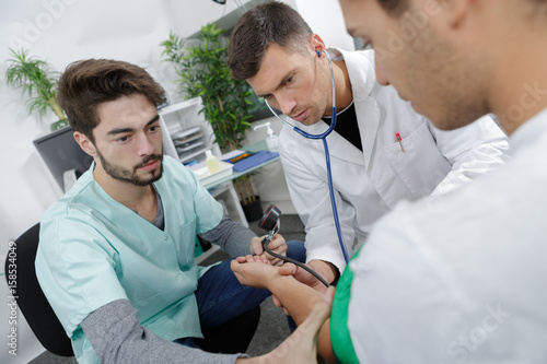 Student nurse taking patient's bloodpressure