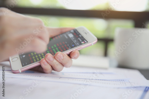 Wallpaper Mural trading online on smartphone with bussiness woman hand Torontodigital.ca