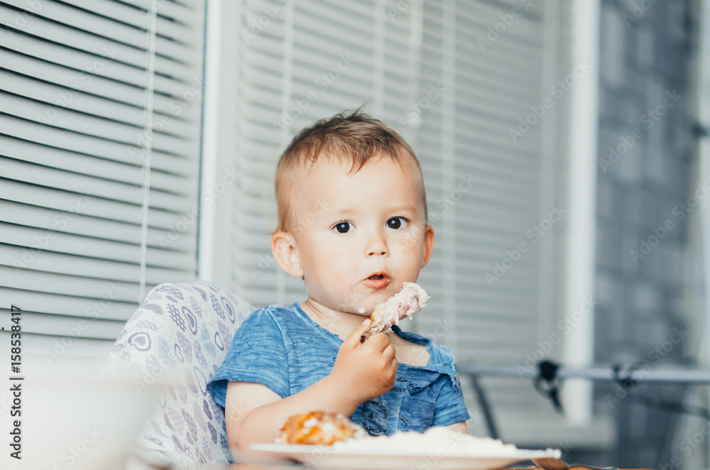 The child eats Lunch,meat chicken The child eats Lunch,meat chicken
